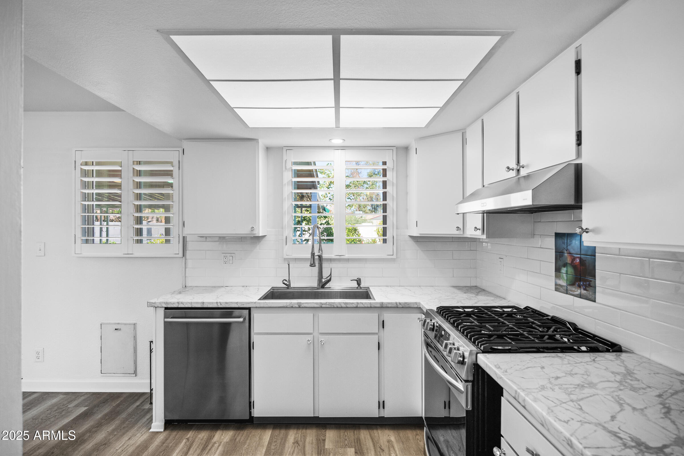 1614 West Inverness Drive Tempe, AZ 85282 - Photo 12 of 27 a kitchen with cabinets appliances a sink and a window
