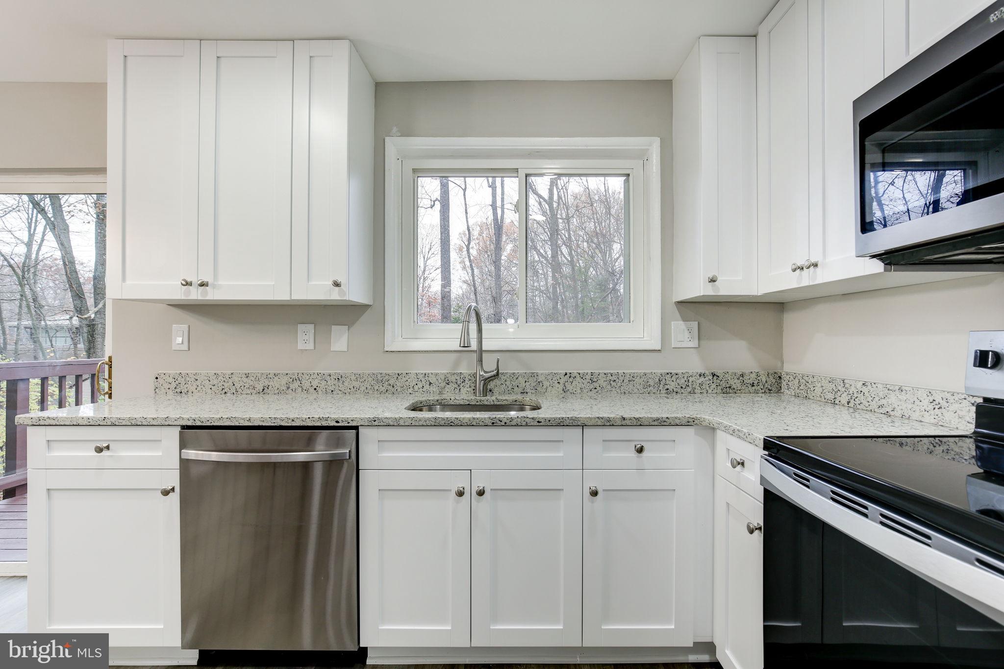 2394 Southgate Square Reston, VA 20191 - Photo 14 of 58 a kitchen with white cabinets and a window