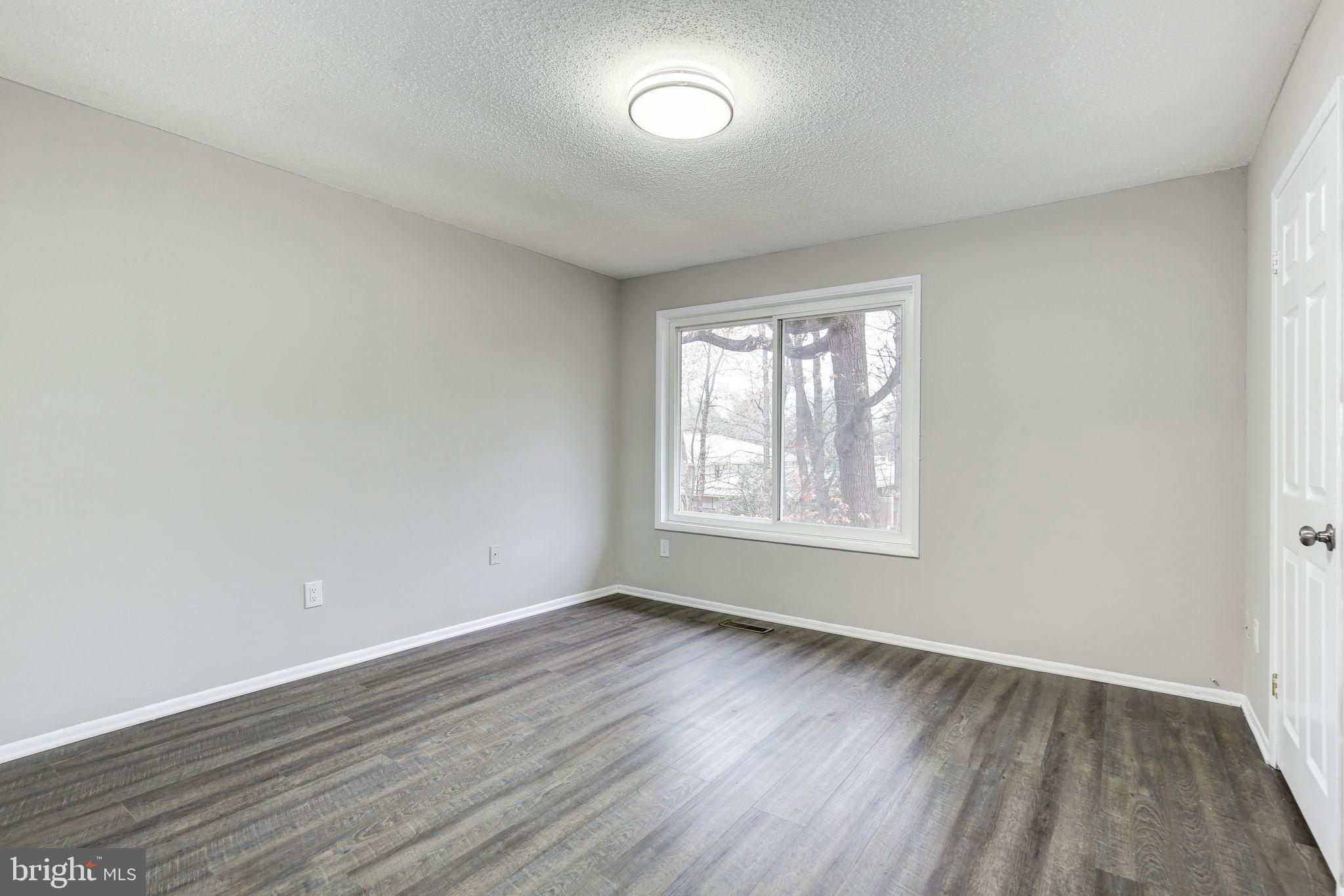 2394 Southgate Square Reston, VA 20191 - Photo 19 of 58 an empty room with wooden floor and windows