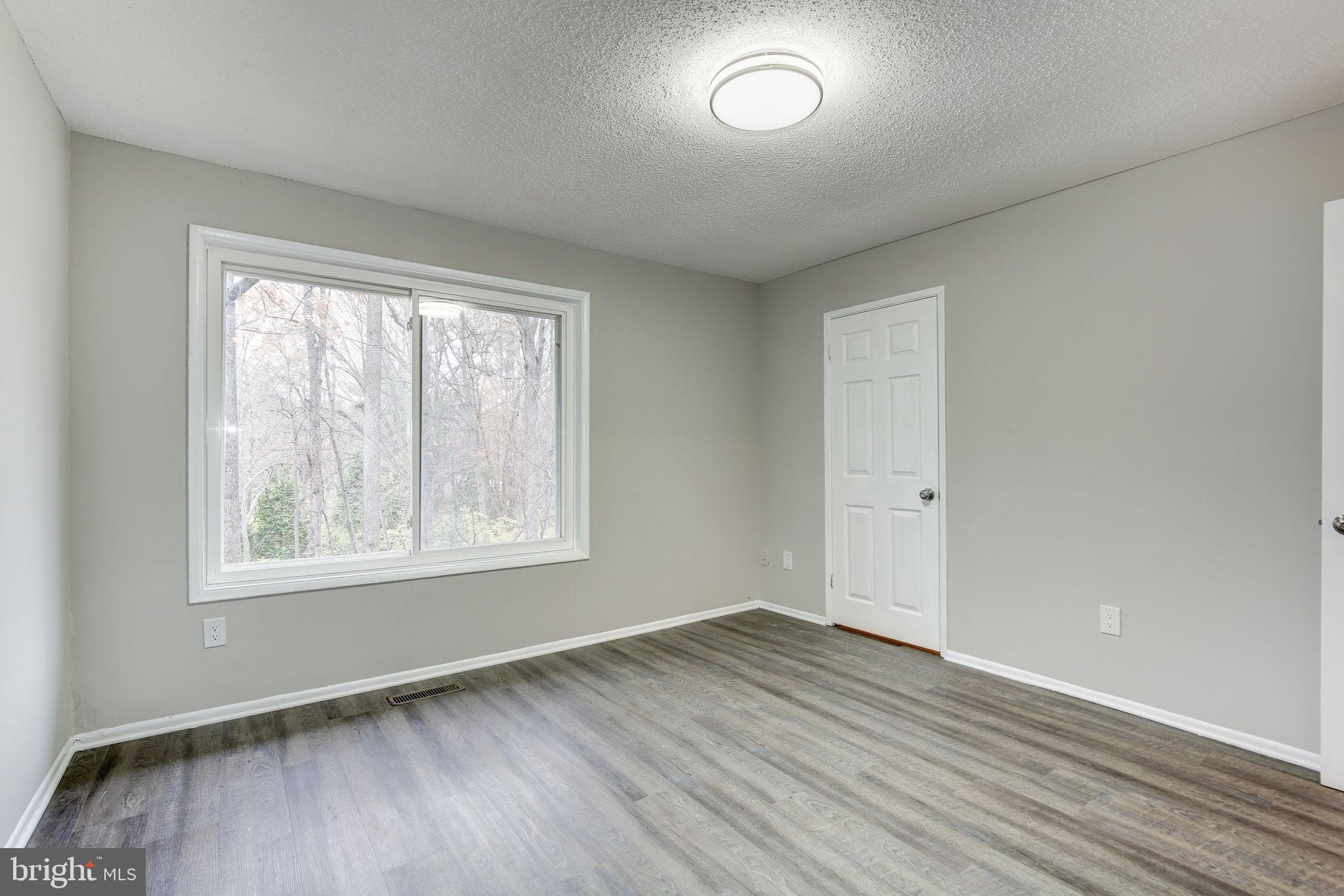 2394 Southgate Square Reston, VA 20191 - Photo 21 of 58 an empty room with wooden floor and windows
