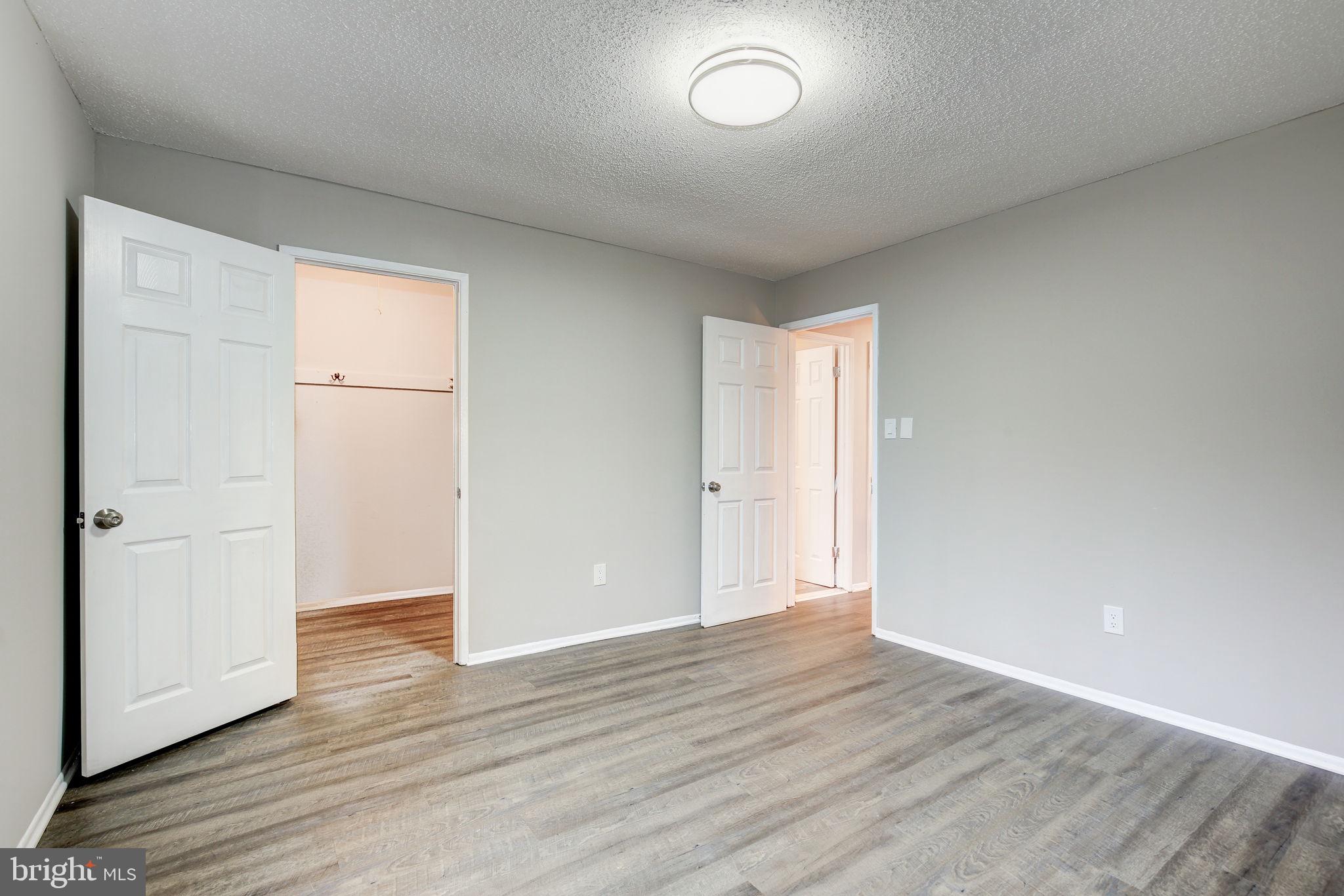 2394 Southgate Square Reston, VA 20191 - Photo 22 of 58 an empty room with wooden floor and closet