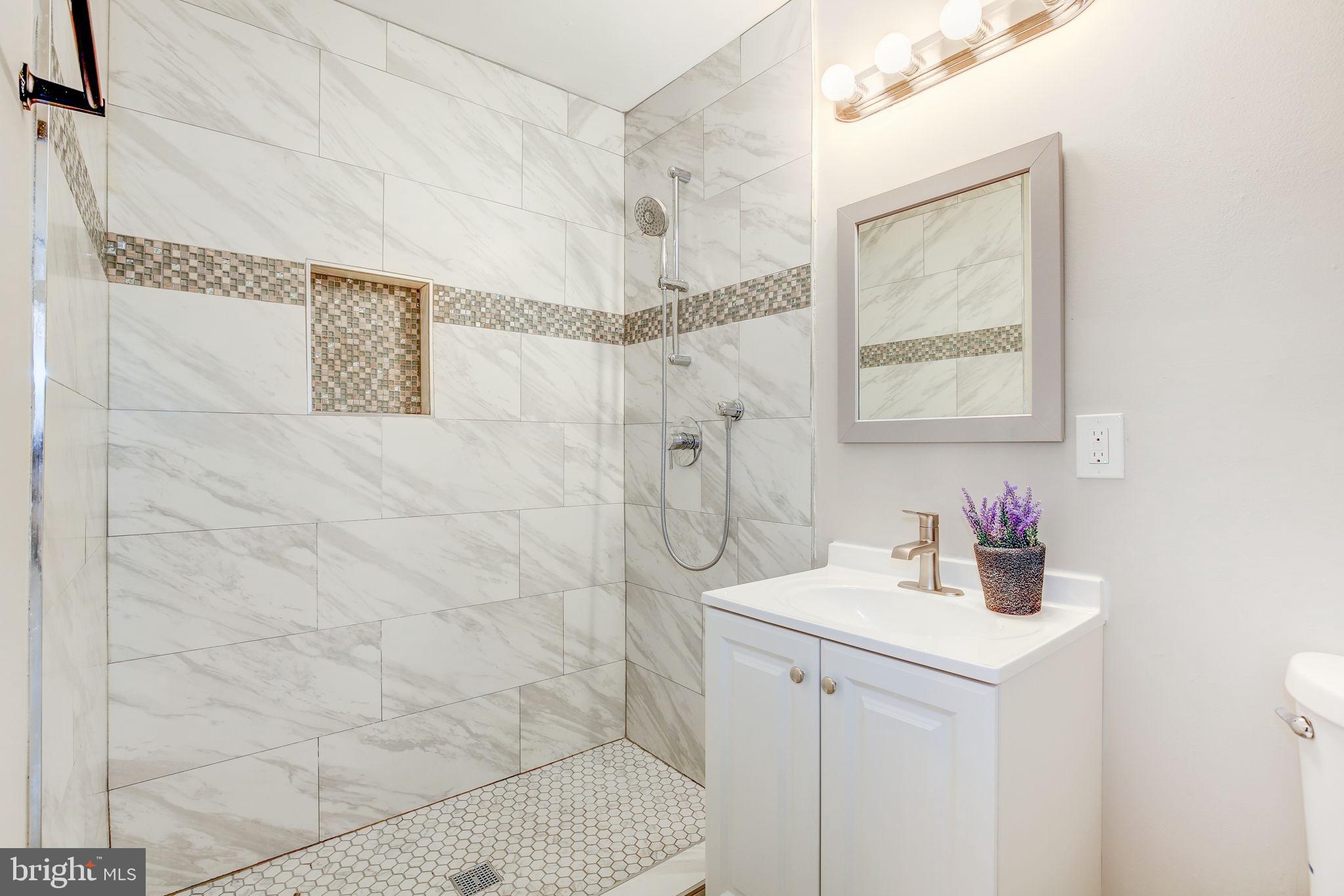 2394 Southgate Square Reston, VA 20191 - Photo 25 of 58 a bathroom with a sink a vanity and shower