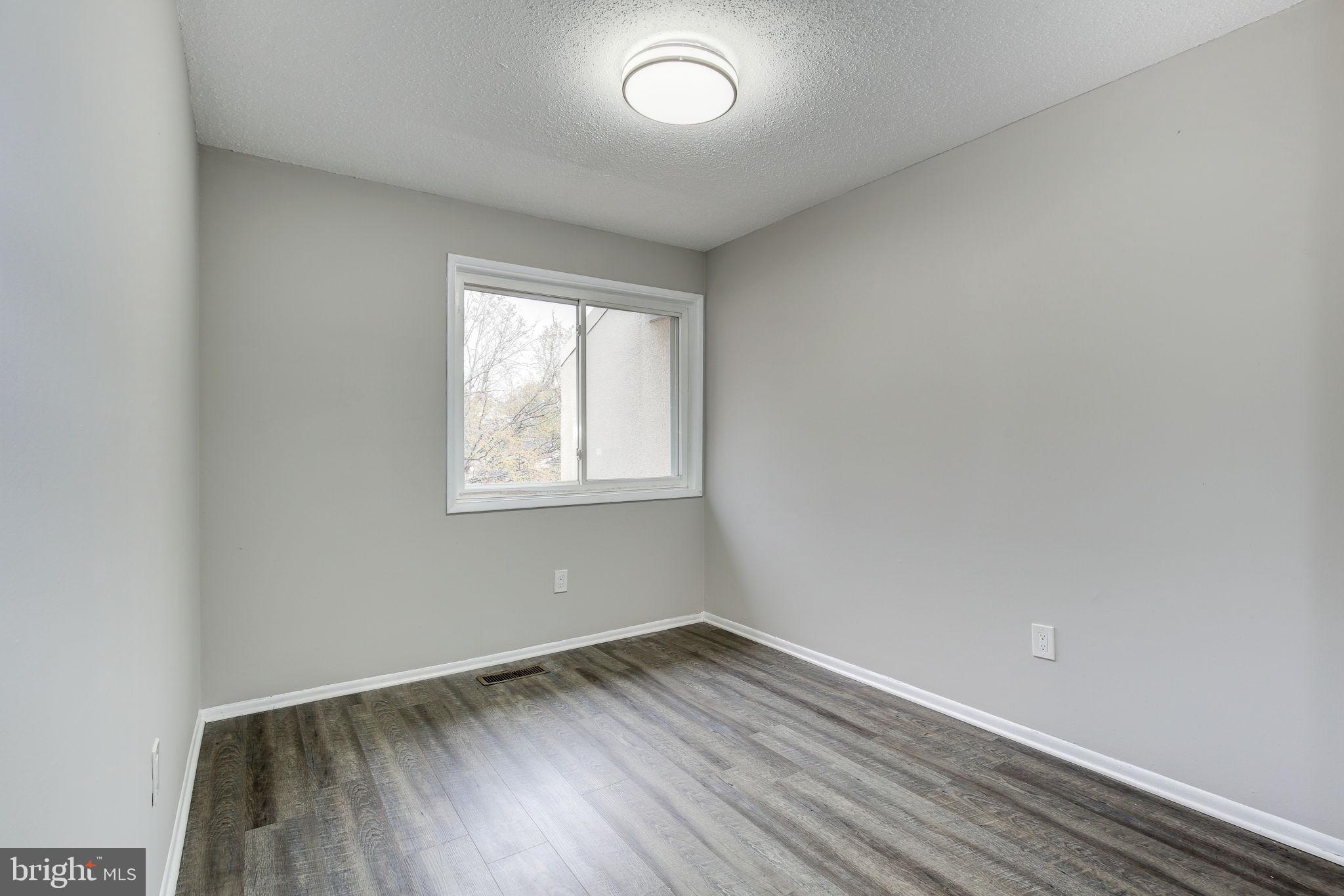 2394 Southgate Square Reston, VA 20191 - Photo 27 of 58 an empty room with wooden floor and windows
