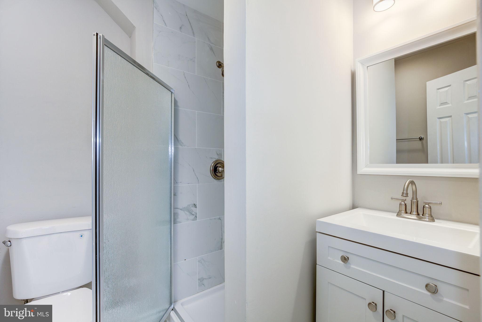 2394 Southgate Square Reston, VA 20191 - Photo 42 of 58 a bathroom with a sink a toilet and a mirror