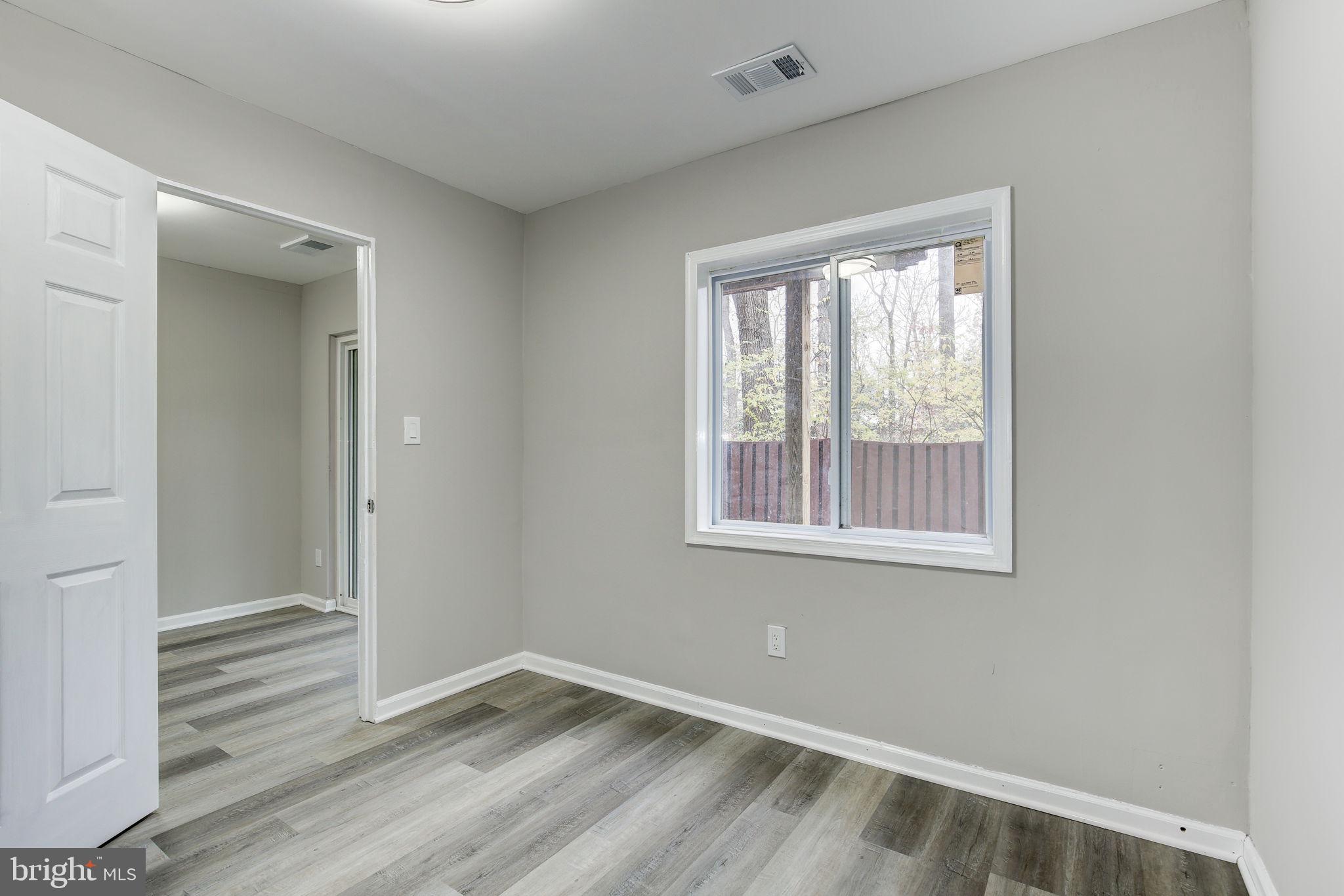 2394 Southgate Square Reston, VA 20191 - Photo 48 of 58 an empty room with wooden floor and windows