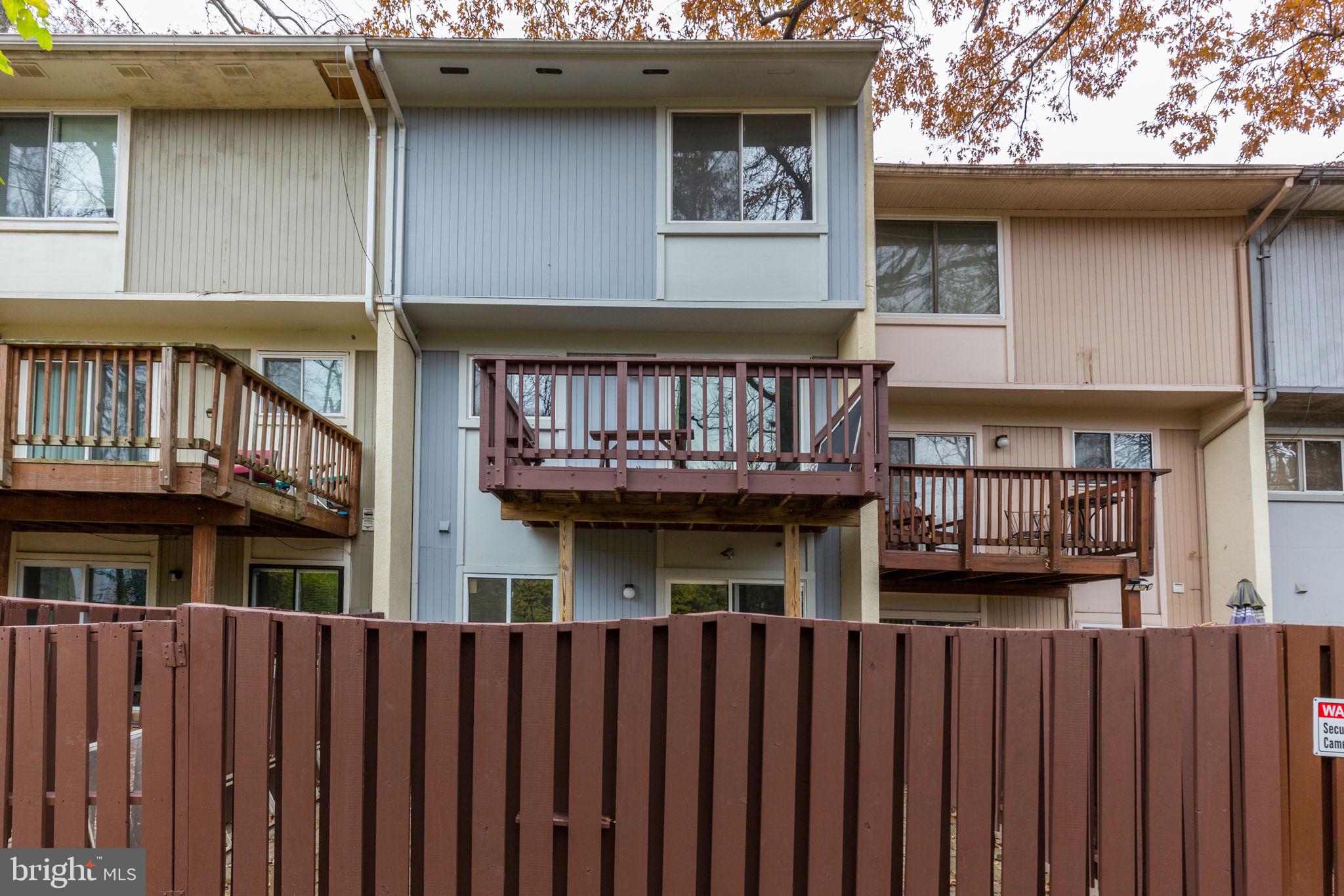 2394 Southgate Square Reston, VA 20191 - Photo 56 of 58 a front view of a house with a wooden deck
