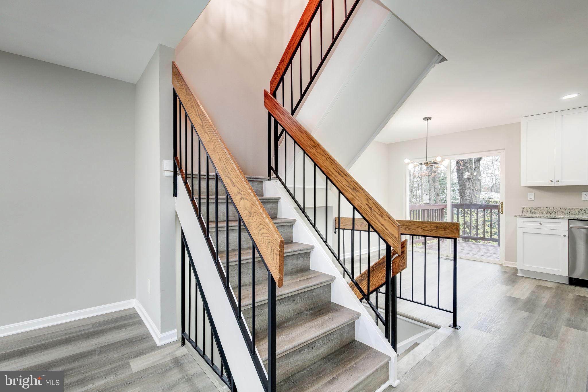 2394 Southgate Square Reston, VA 20191 - Photo 7 of 58 a view of staircase with wooden floor and a rug