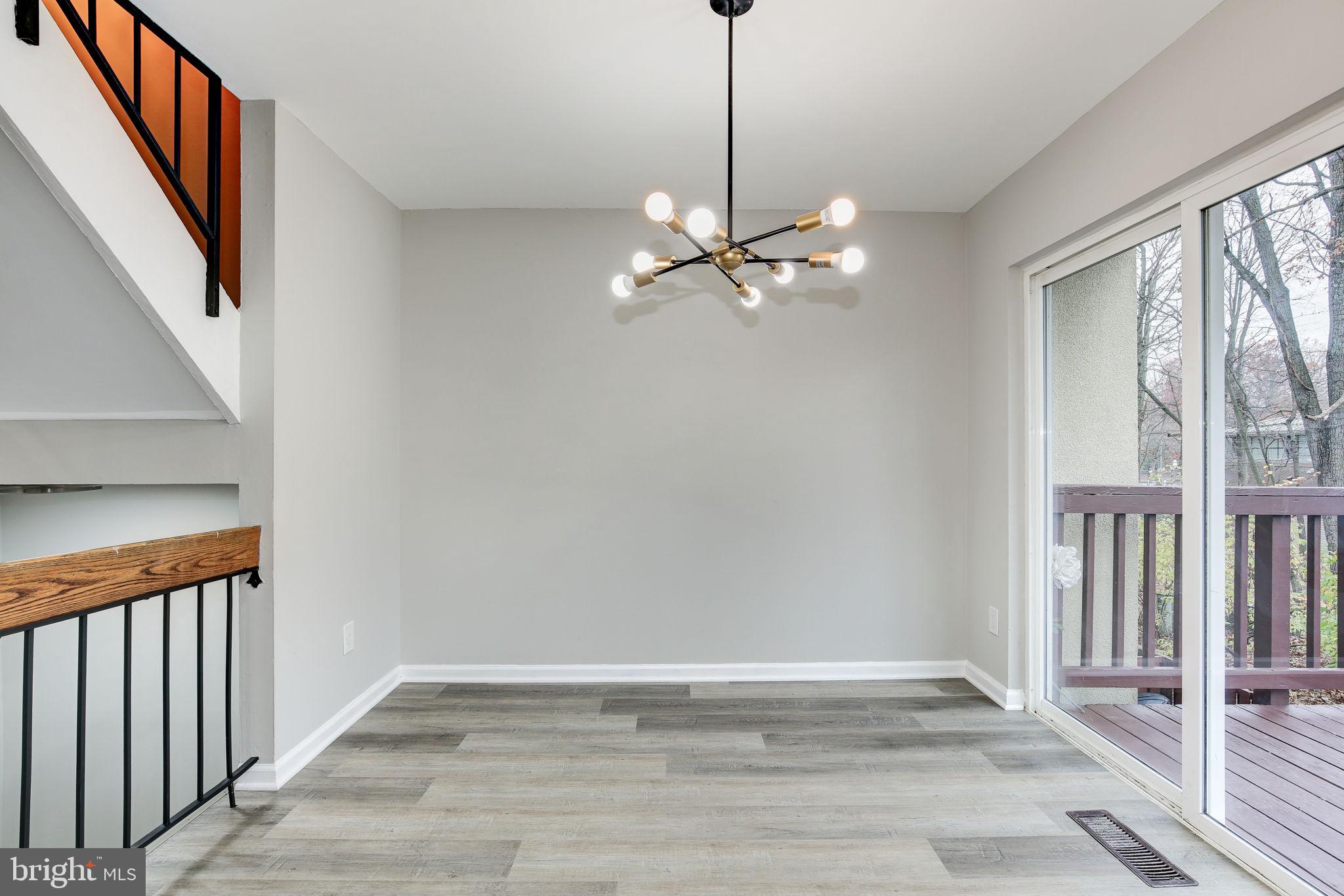 2394 Southgate Square Reston, VA 20191 - Photo 9 of 58 a view of an empty room with wooden floor and a window
