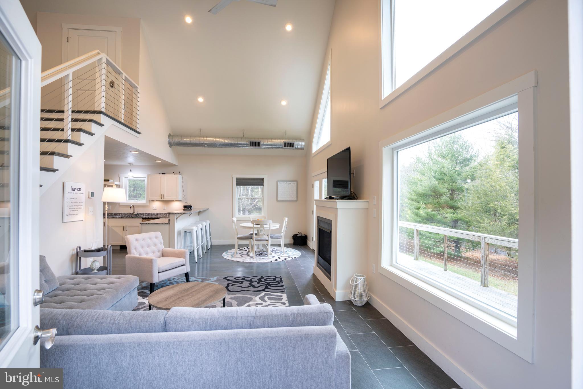 512 Decker Valley Road Spring Mills, PA 16875 - Photo 17 of 66 a living room with furniture fireplace and a large window