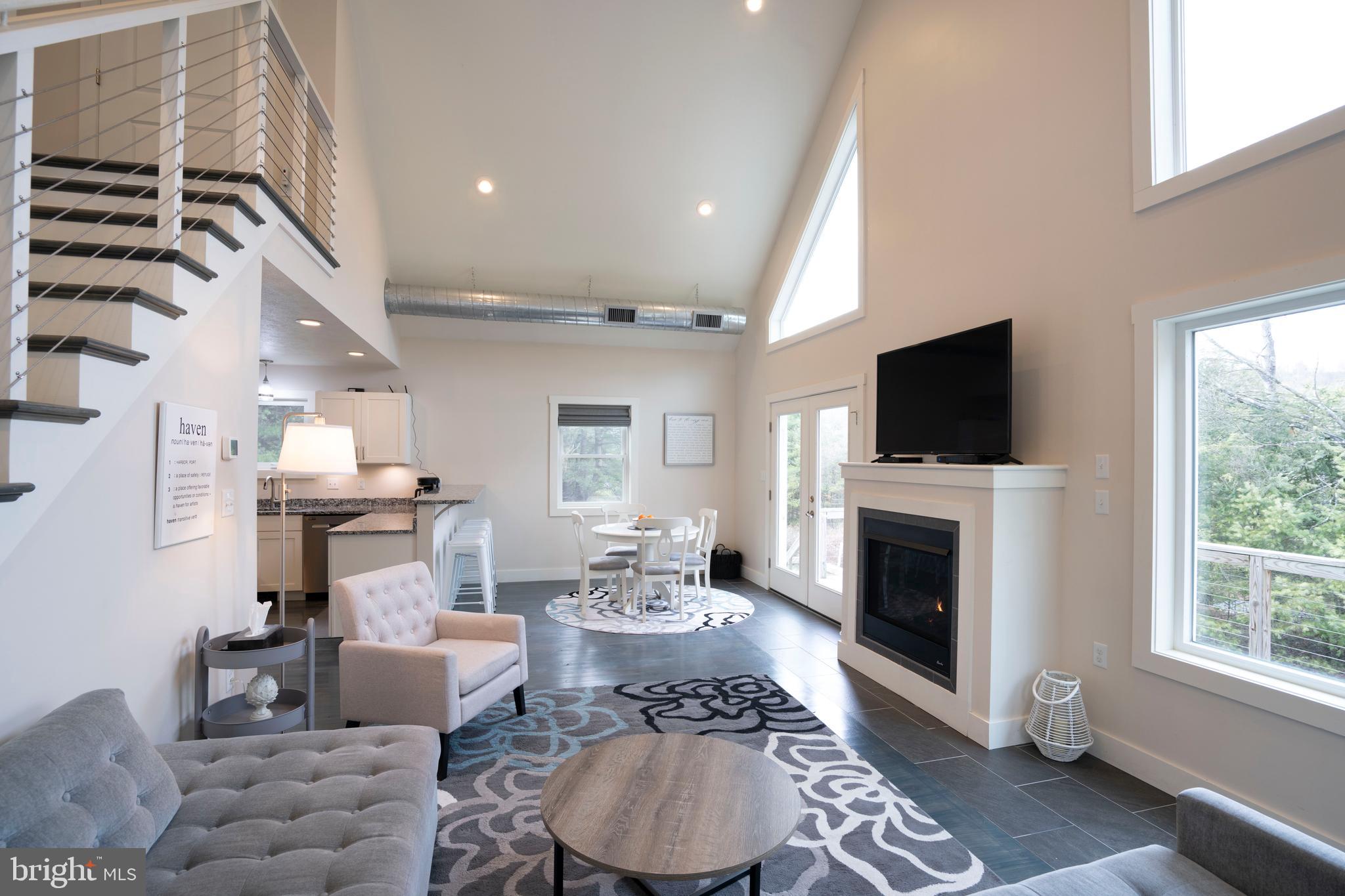 512 Decker Valley Road Spring Mills, PA 16875 - Photo 19 of 66 a living room with furniture a flat screen tv and a fireplace