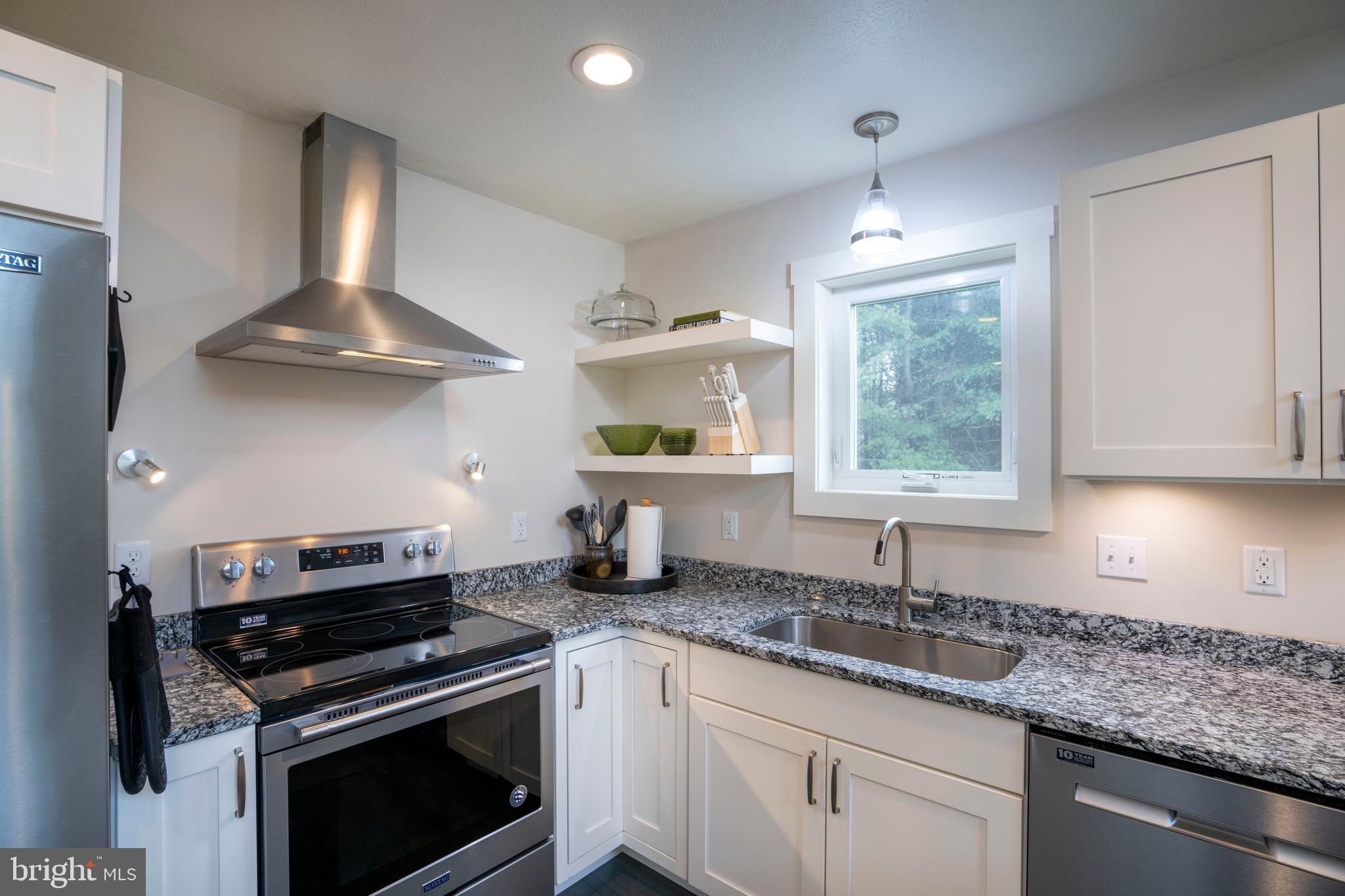 512 Decker Valley Road Spring Mills, PA 16875 - Photo 26 of 66 a kitchen with granite countertop stainless steel appliances a sink stove and window