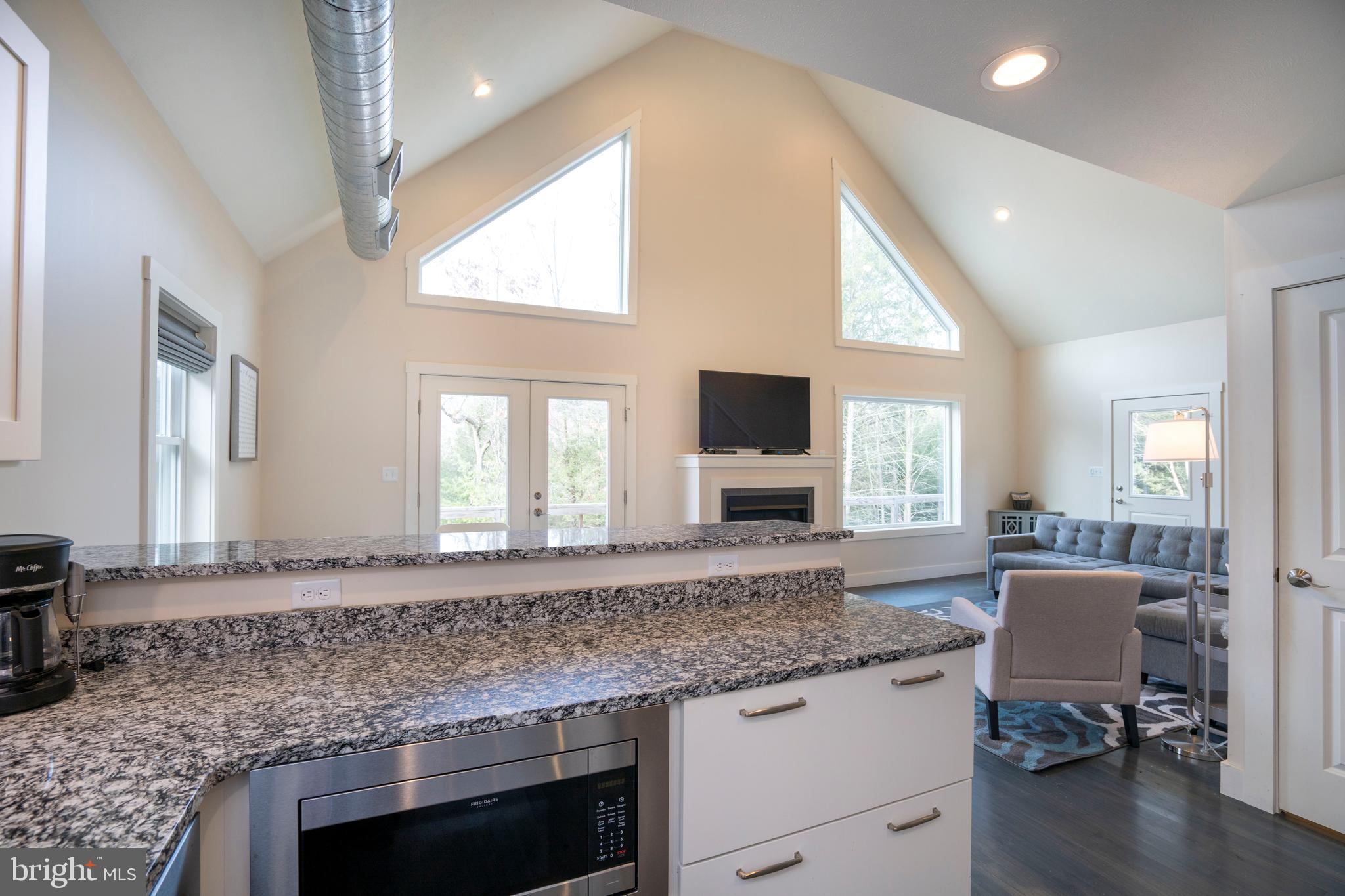 512 Decker Valley Road Spring Mills, PA 16875 - Photo 29 of 66 a kitchen with granite countertop cabinets stainless steel appliances a sink and a large window