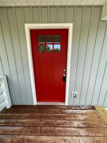 a kitchen with granite countertop white cabinets and stainless steel appliances