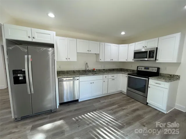 a stove top oven sitting inside of a kitchen
