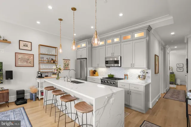 a kitchen with stainless steel appliances kitchen island granite countertop a sink and cabinets