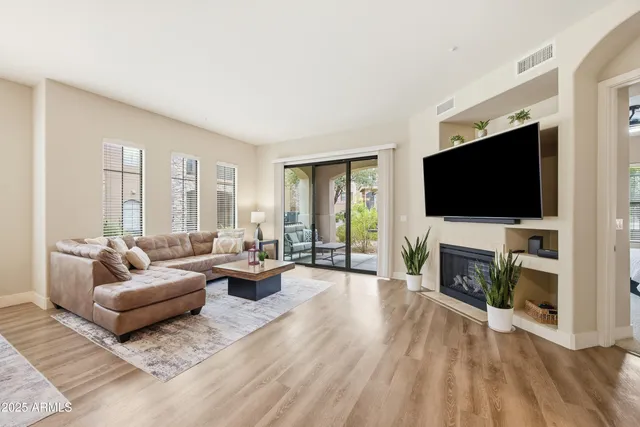a living room with fireplace furniture and a flat screen tv