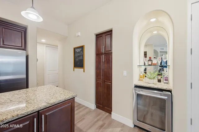 a kitchen with stainless steel appliances granite countertop a refrigerator and stove