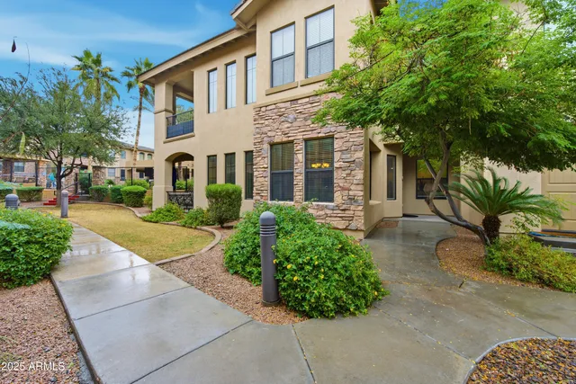 front view of a brick house with a yard