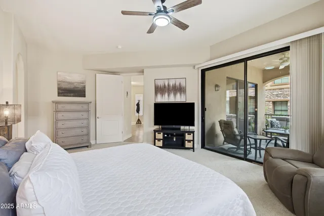 a bedroom with a bed and a television