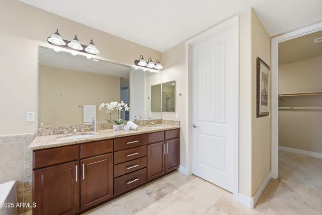a bathroom with a double vanity sink and mirror