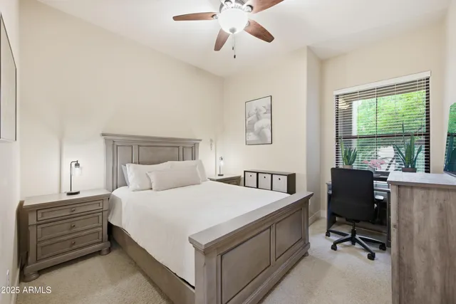 a bedroom with a bed and a desk