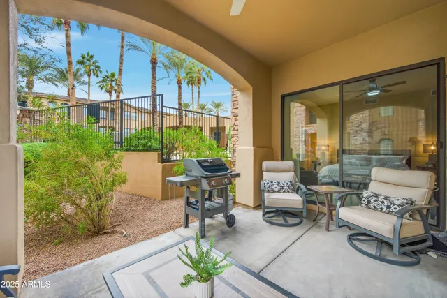 a living room with furniture and a floor to ceiling window