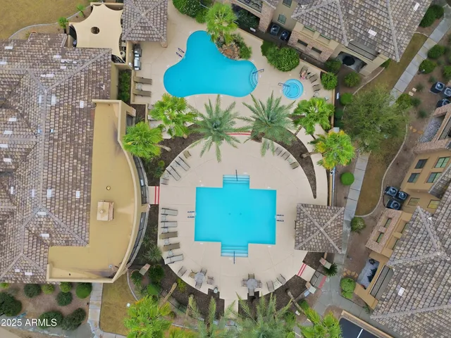 an aerial view of a house with a swimming pool and outdoor seating