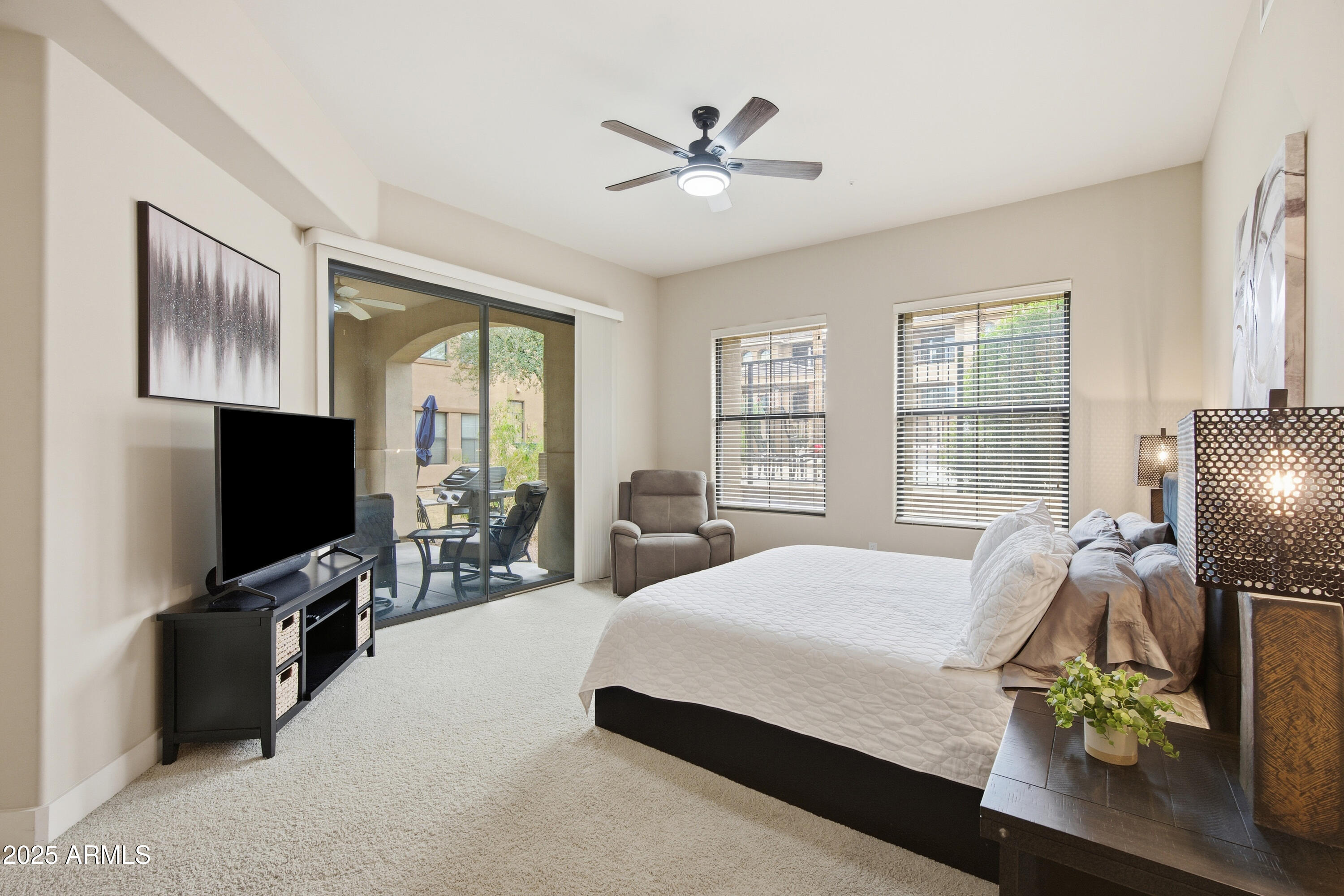 15550 South 5th Avenue, Unit 159 Phoenix, AZ 85045 - Photo 5 of 44 a bedroom with a bed and a flat tv screen on the dresser