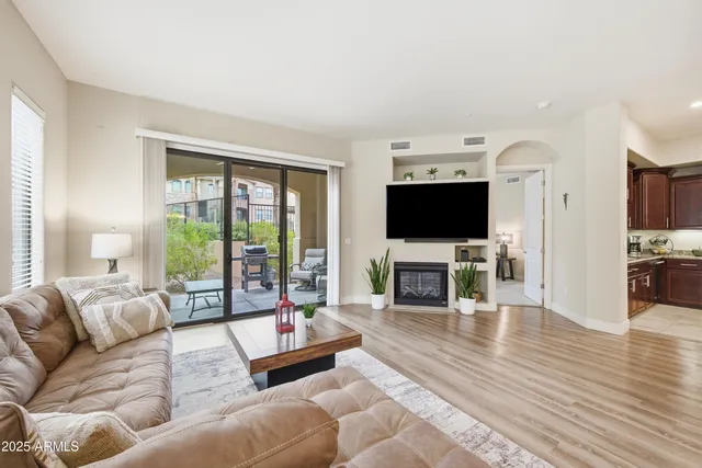 a living room with fireplace furniture and a flat screen tv