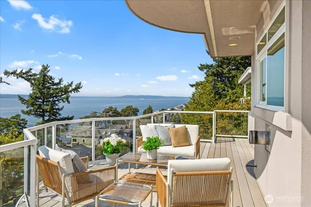 a view of a chair and tables in the balcony