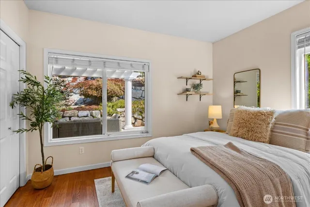 a bedroom with a large bed and a wooden floor