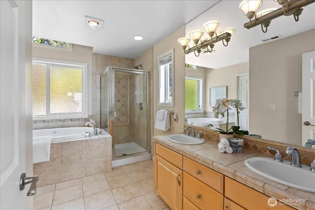 a spacious bathroom with a tub sink and mirror