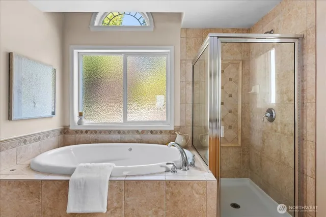 a bathroom with a tub a sink and a shower