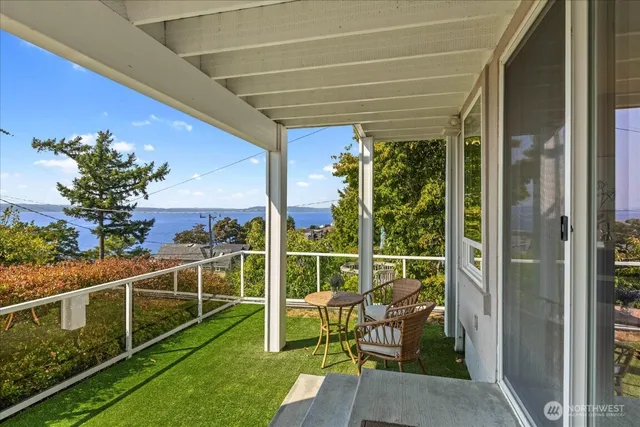 a view of a two chair in the patio next to a yard
