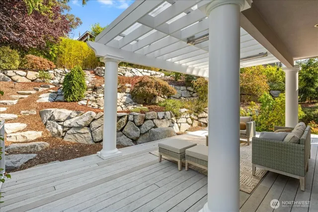 a balcony with wooden floor and outdoor seating