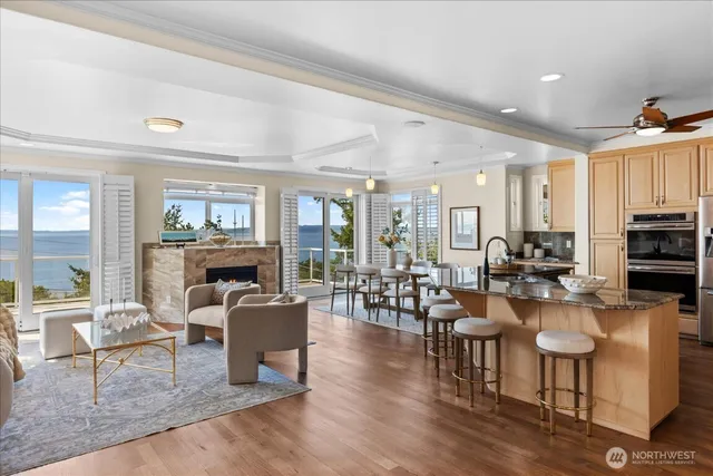 a living room with fireplace furniture and a wooden floor