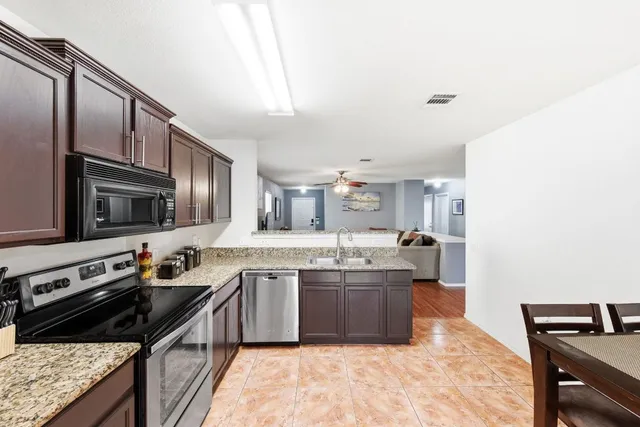 a view of large yard with wooden fence