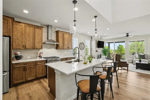 a large kitchen with a table and chairs