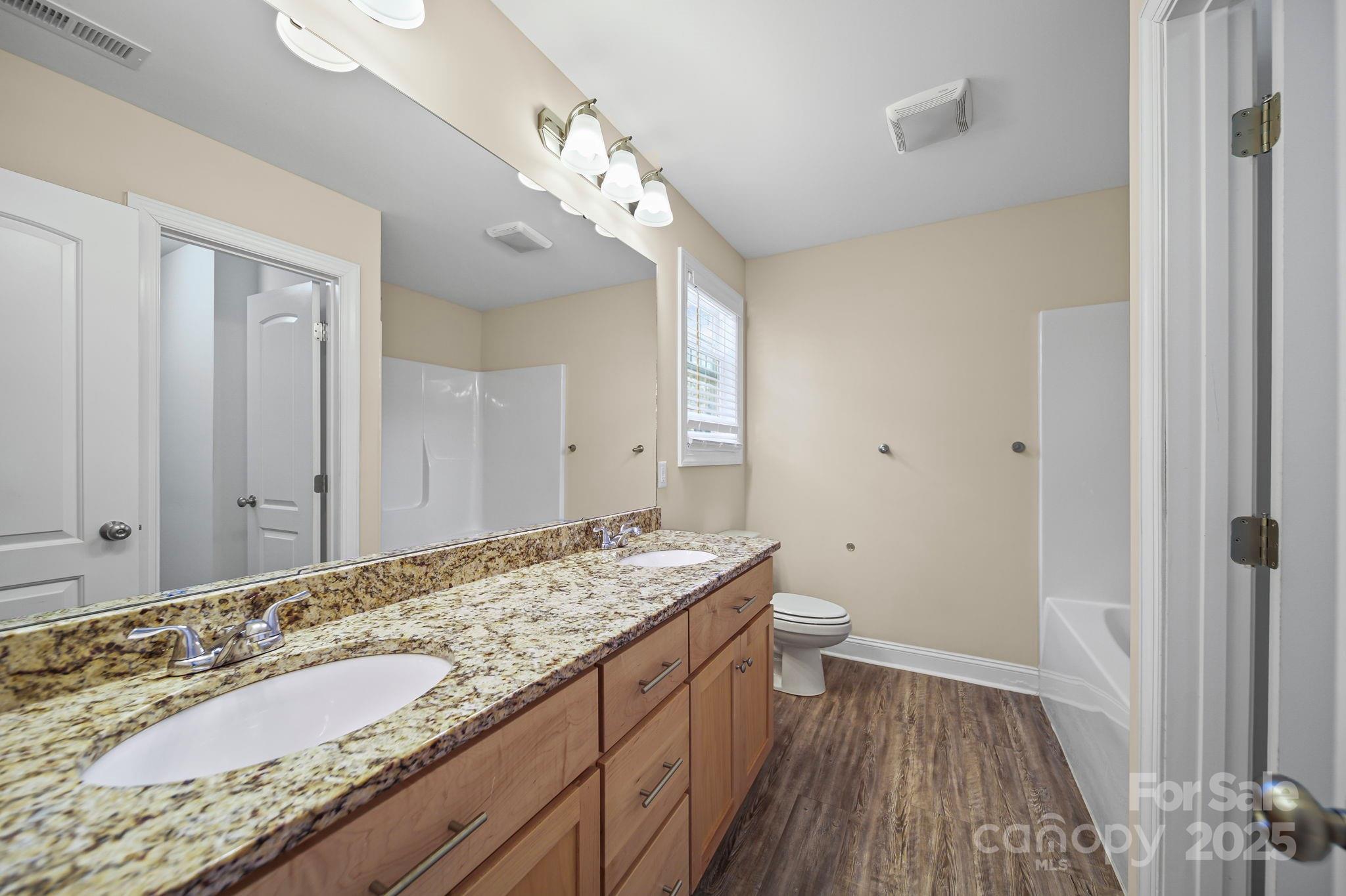 157 Crescent Street Kannapolis, NC 28081 - Photo 21 of 36 a bathroom with a granite countertop sink a toilet and shower