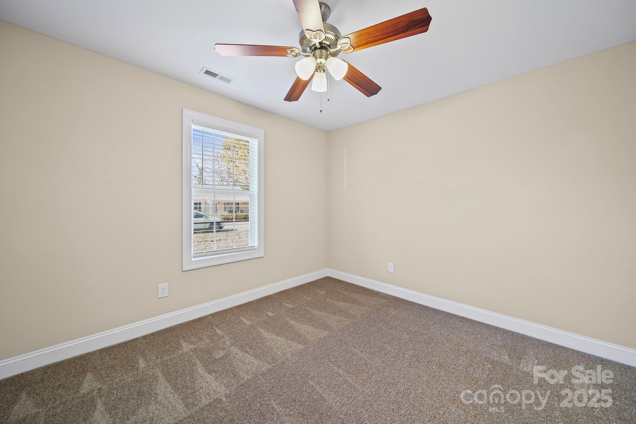 157 Crescent Street Kannapolis, NC 28081 - Photo 27 of 36 an empty room with windows and fan