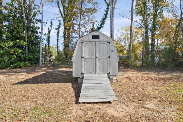 a pathway of a house with a yard