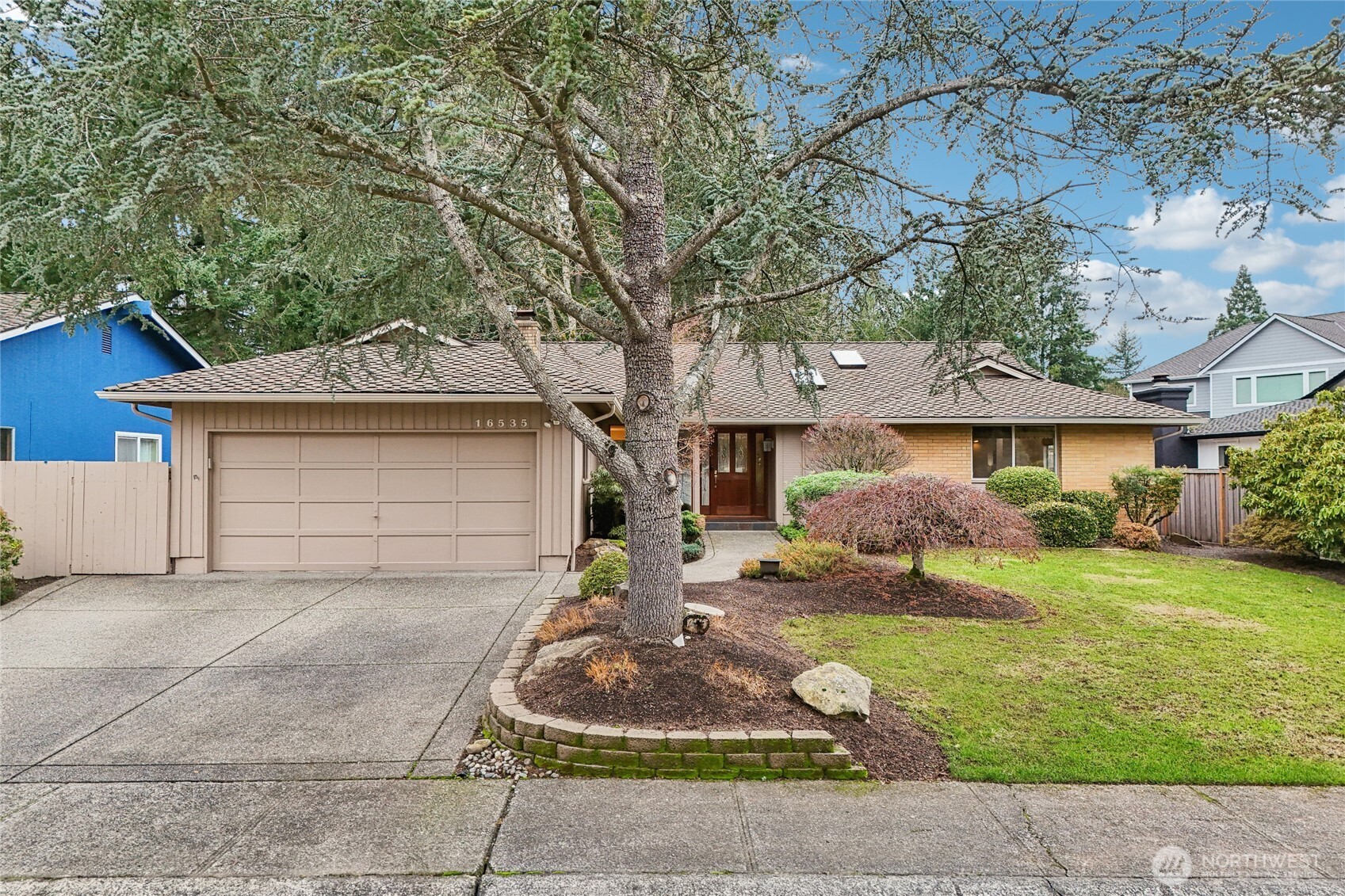 a front view of a house with a yard and garage