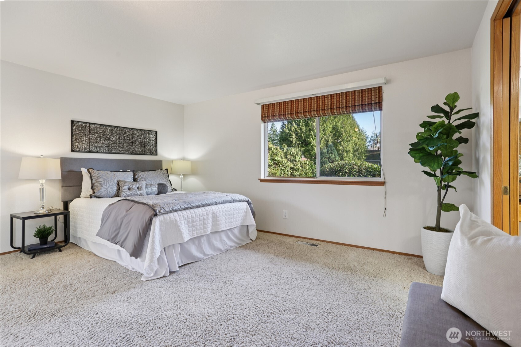 16535 147th Avenue Southeast Renton, WA 98058 - Photo 17 of 37 a bedroom with a large bed and a potted plant