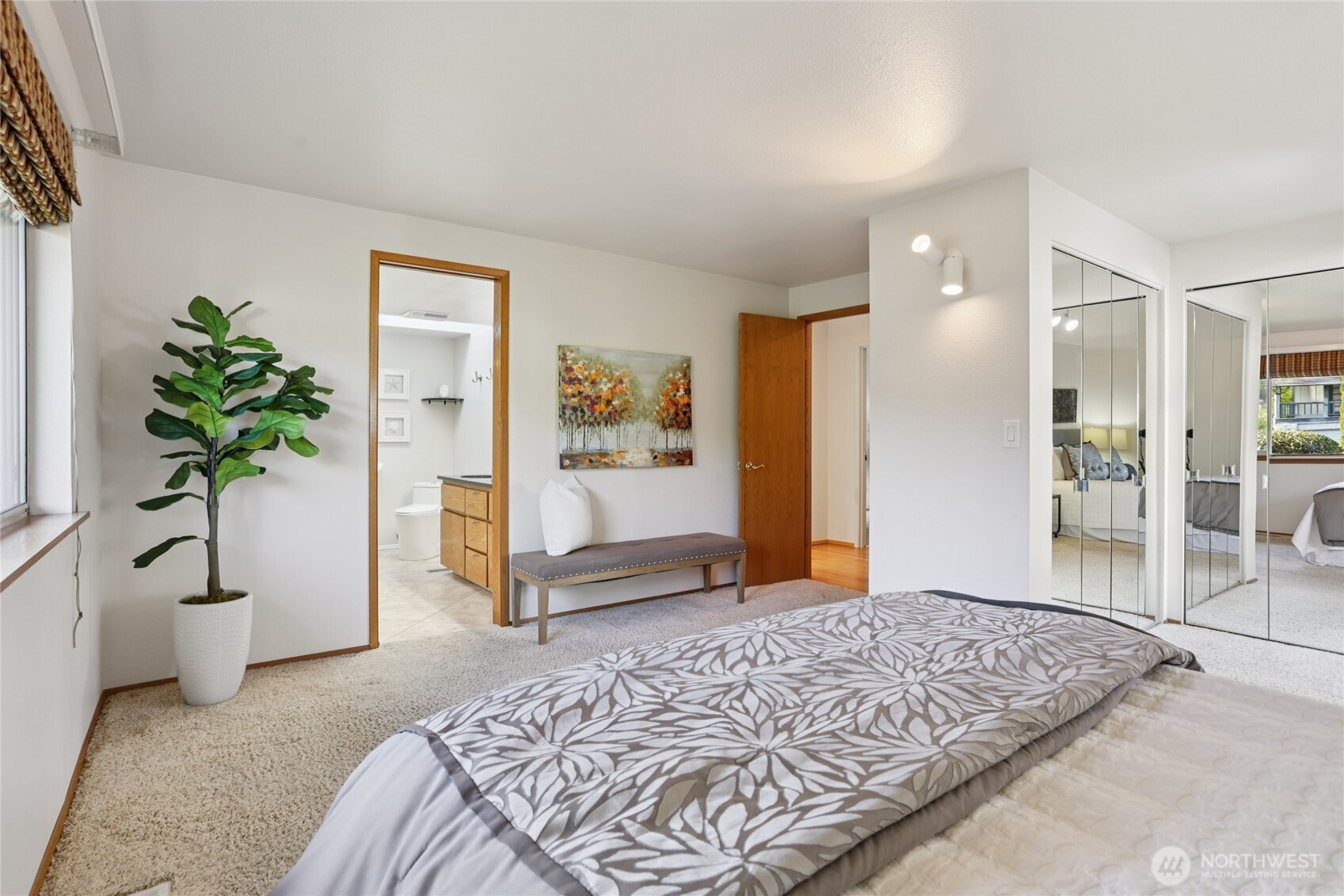 16535 147th Avenue Southeast Renton, WA 98058 - Photo 20 of 37 a bedroom with a large bed and a potted plant