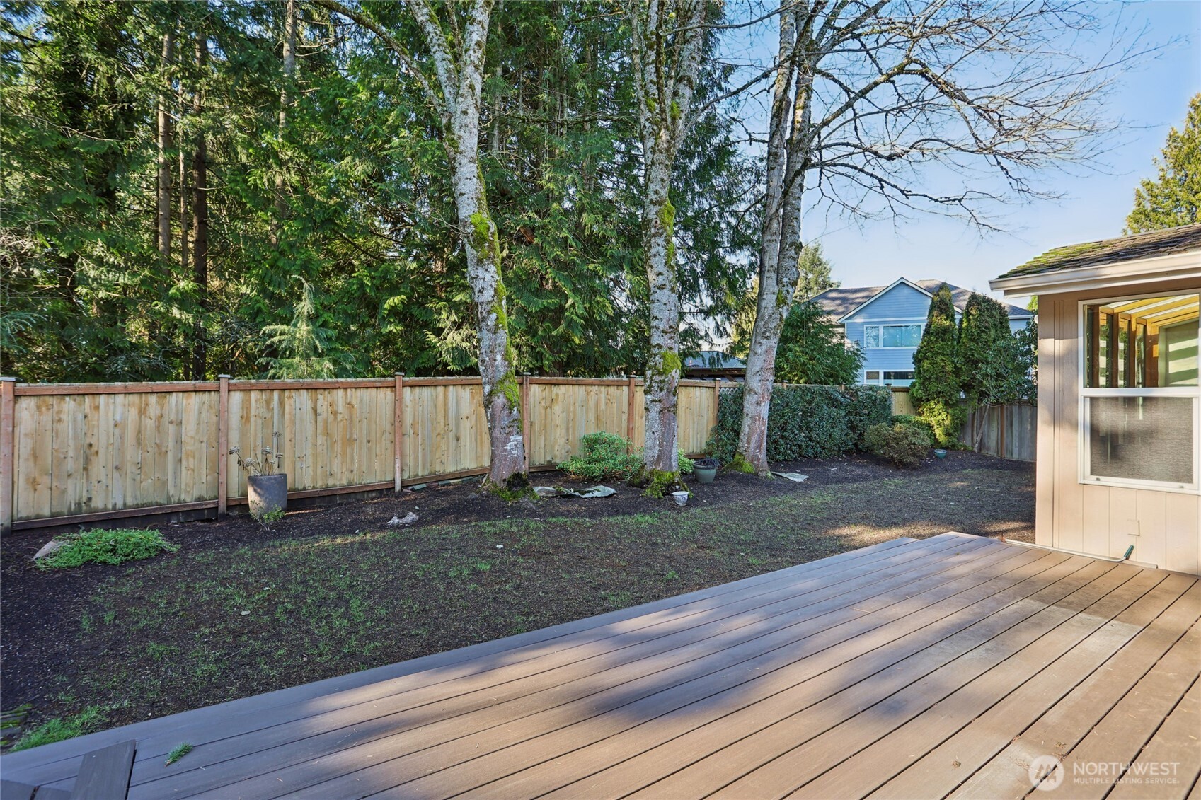 16535 147th Avenue Southeast Renton, WA 98058 - Photo 31 of 37 a view of a backyard with plants and wooden fence