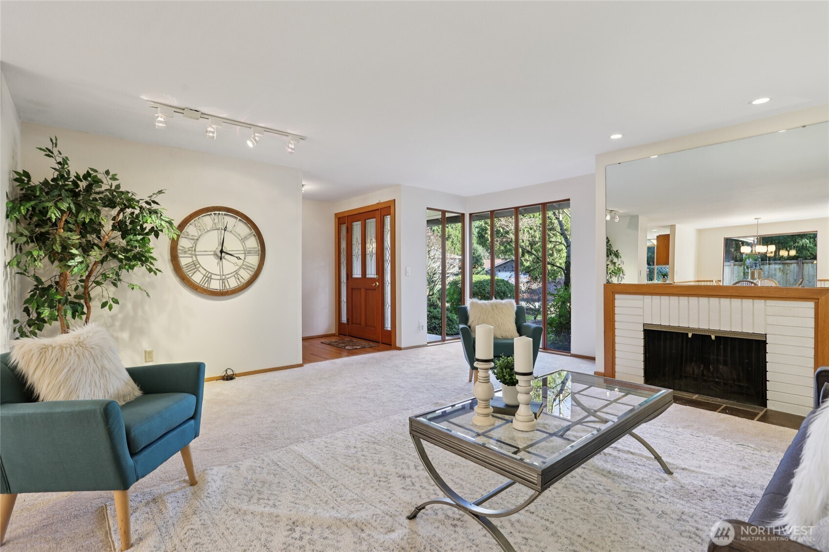 16535 147th Avenue Southeast Renton, WA 98058 - Photo 4 of 37 a living room with furniture a clock and a fireplace