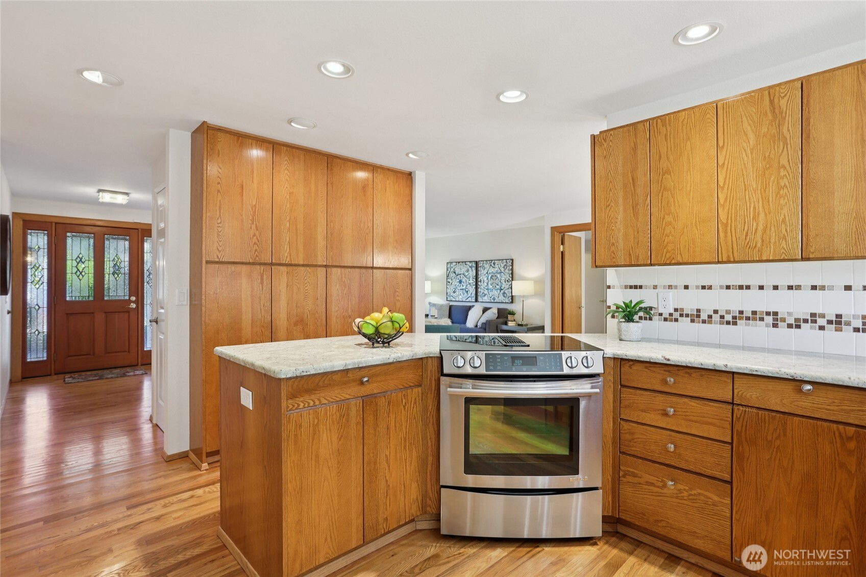 16535 147th Avenue Southeast Renton, WA 98058 - Photo 8 of 37 a kitchen with granite countertop cabinets stainless steel appliances and wooden floor