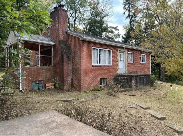 a house that has a tree in front of it