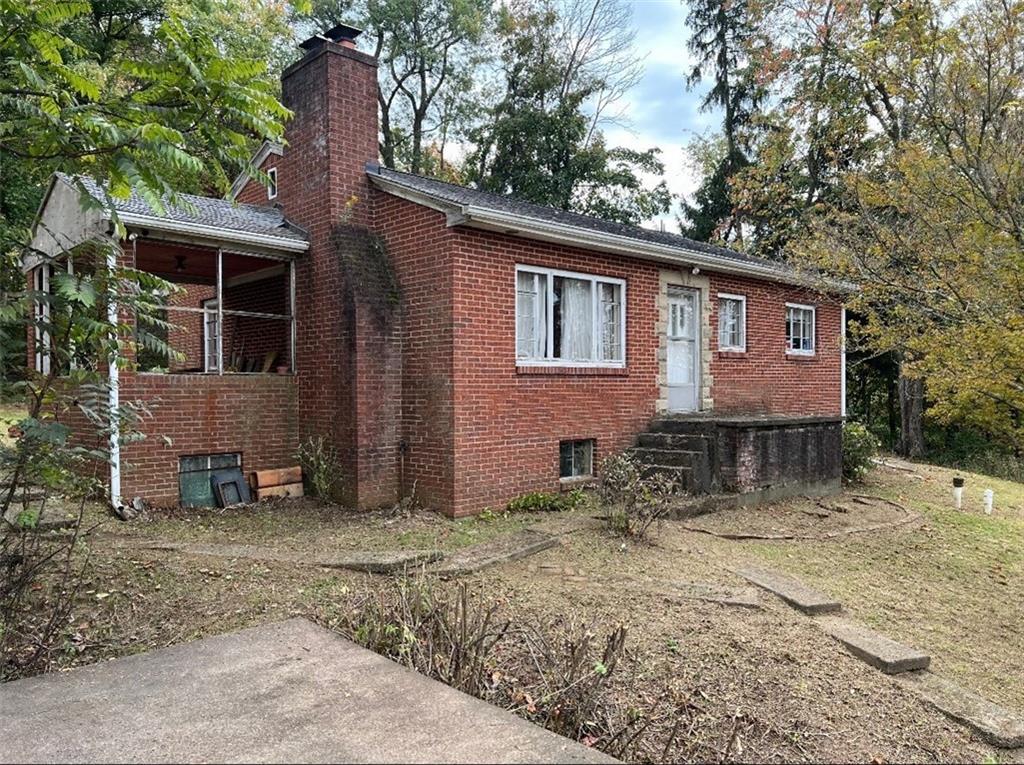 a house that has a tree in front of it