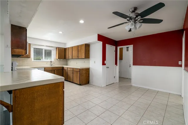 a kitchen with refrigerator cabinets and window